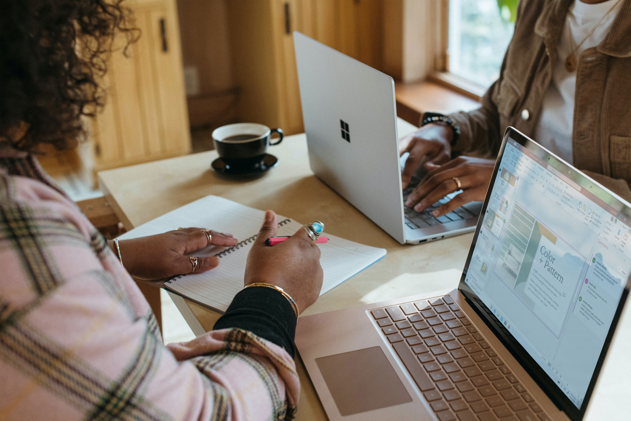 two women with laptops